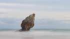 Spain, Playa Buelna. Lone ocean sea stack on misty coastline. Art Print